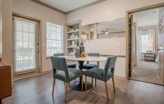 a dining room with a table and chairs in front of a window at Reserve by the Lake, Texas