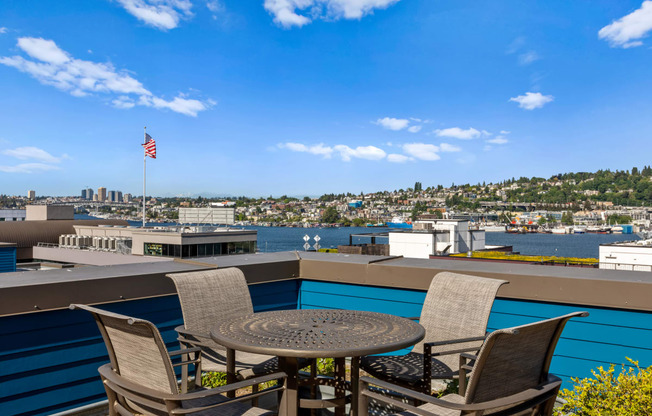 a patio with a table and four chairs overlooks a body of water at Dexter Lake Union, Seattle, WA, 98109