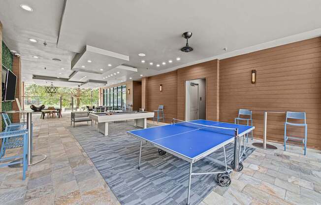 a game room with ping pong tables and a pool table