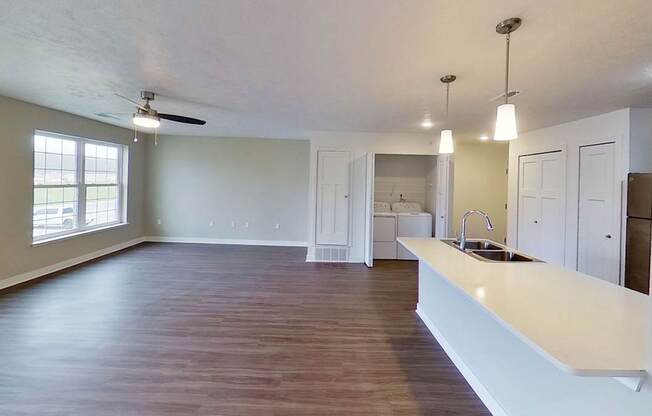 A dining room and kitchen with a breakfast bar at Meadowbrooke Apartment Homes in Kentwood, MI 49512