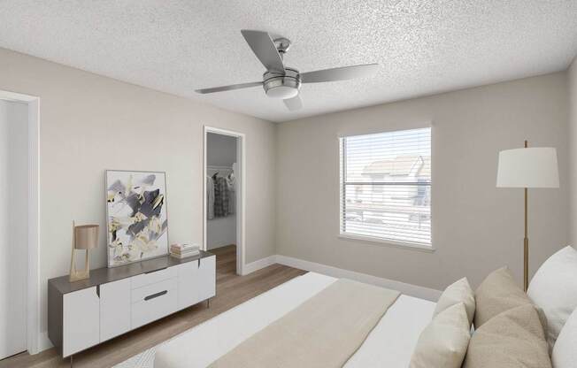 A living room with a white couch and a ceiling fan.