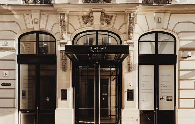 the facade of a building with two black doors at Chateau on Wells, Chicago, IL