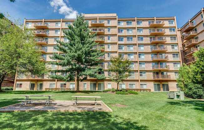 A large apartment building with a playground in front.