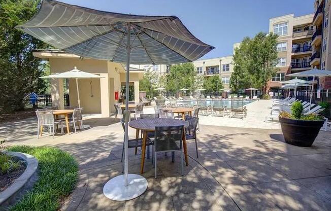 A patio with a table and chairs under a canopy.