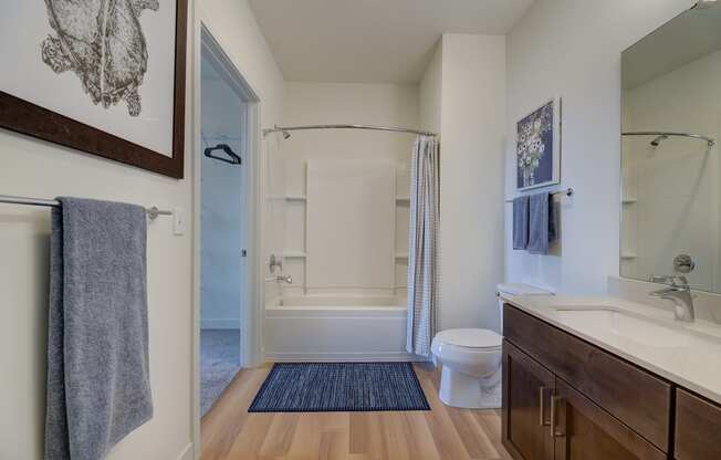 a bathroom with a shower toilet and sink and a mirror at Statesman Apartments, Franklin