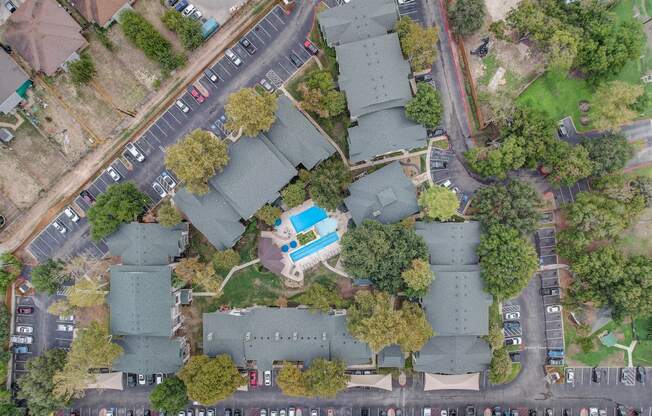 an aerial view of a neighborhood with houses and a street