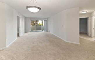 Carpeted Living Room with Balcony