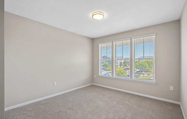 an empty living room with a large window