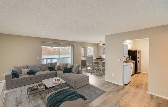 A living room with a grey couch and a coffee table.
