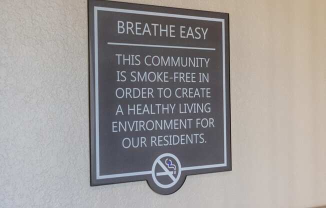 a sign that says breathe easy this community is smoke free in order to create a healthy living