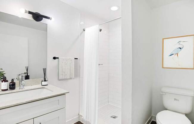 A bathroom with a white toilet and a white sink.