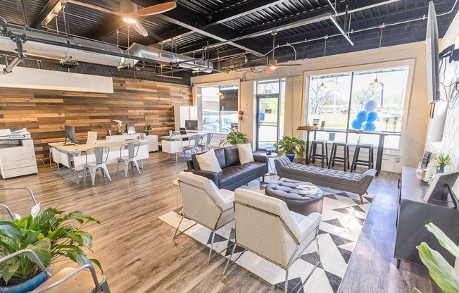 a room with couches chairs and tables in it