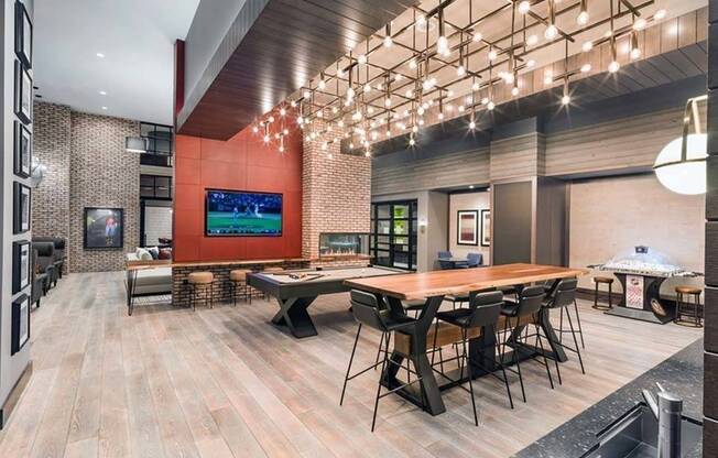 Game room featuring gathering spaces, kitchen area, HDTV and fireplace