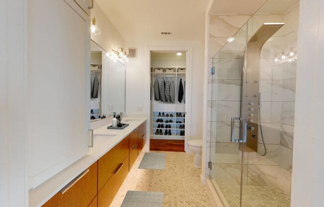 a bathroom with a shower and a sink and a mirror