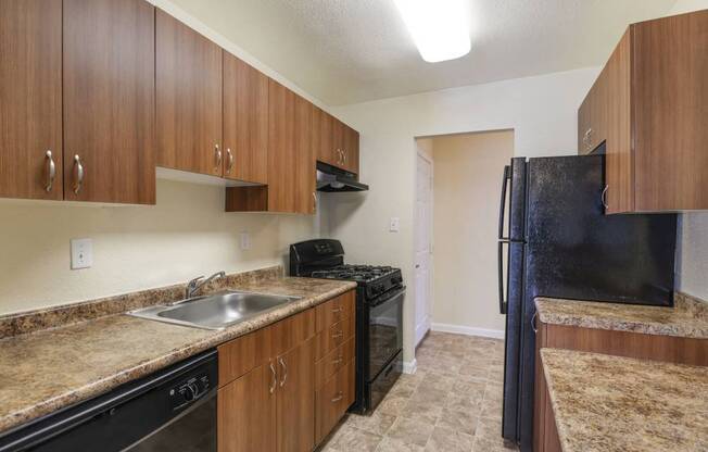 a kitchen with a stove a sink and a refrigerator