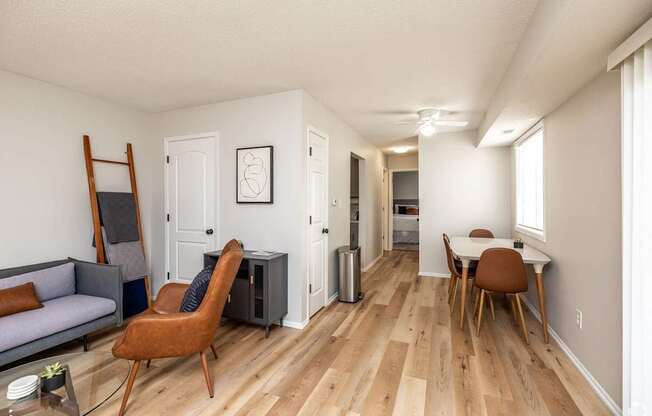 an open living room and dining room with hardwood flooring and a living room