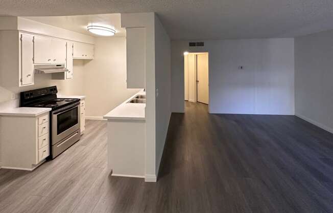 Kitchen and Living Room with Hard Floors and White Cabinets