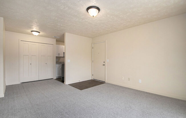 living room and kitchen with plush carpet at Old Farm Apartments, Elkhart, Indiana