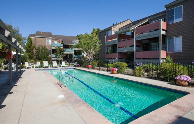 a swimming pool in front of an apartment building