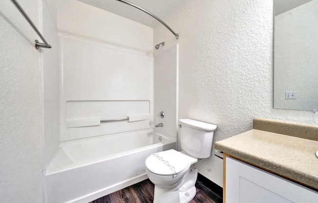 a bathroom with a toilet and a bath tub