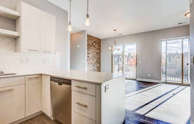 Open floorplan with counter and exposed brick wall