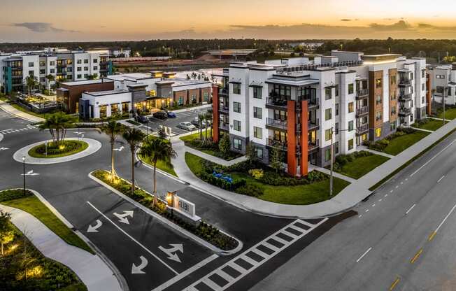 an aerial view of an empty parking lot with apartment buildings