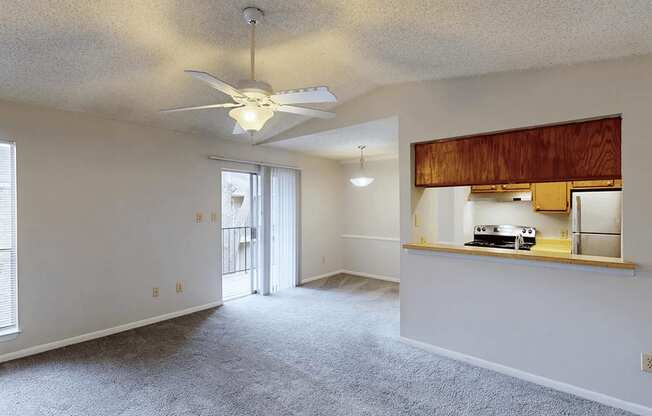 A room with a ceiling fan and a window.