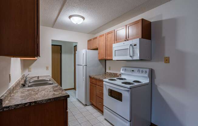 a kitchen with white tile flooring and white appliances at France, North Dakota, 58103