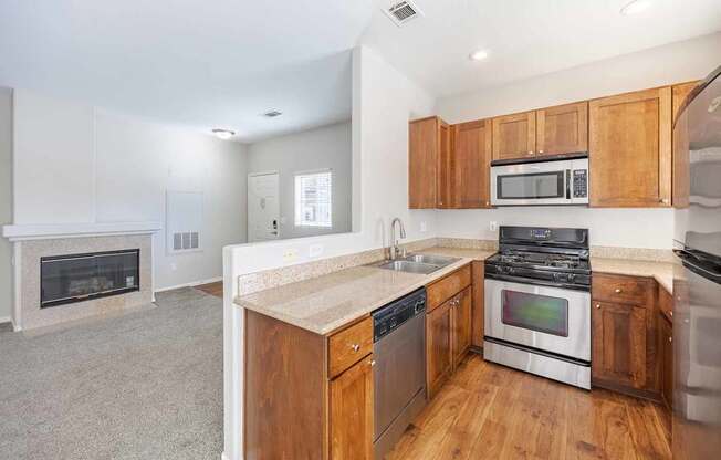 A kitchen with wooden cabinets and a black stove top oven.