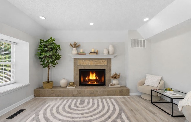 A living room with a fireplace and a tree.