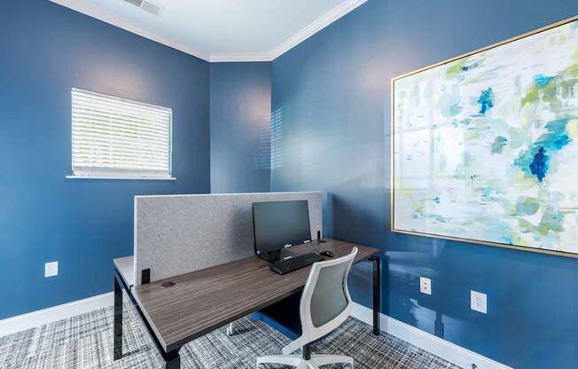 A room with a desk and a computer.