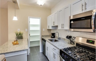 Renovated kitchen with stainless steel appliances and granite countertops  at Kew Gardens, Washington, Washington