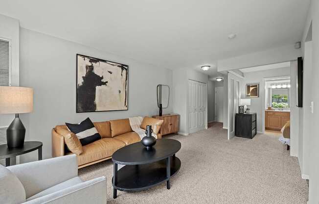 A living room with a couch, coffee table, and lamp.