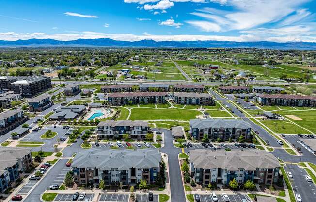 an aerial view of a neighborhood with houses and a parking lot at Arbour Commons, Colorado, 80023