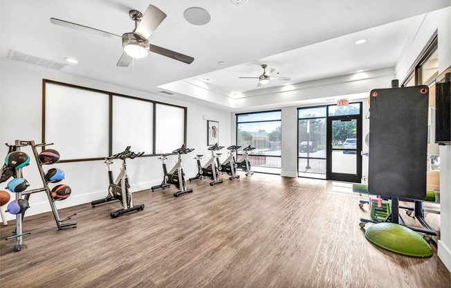 A room with exercise equipment and a green exercise pad.