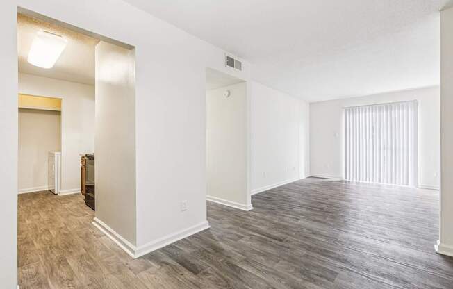 A room with a wooden floor and white walls.