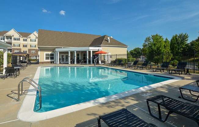 a swimming pool with a building in the background