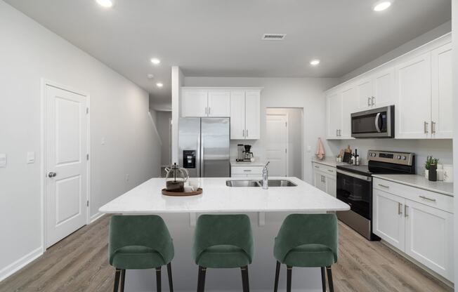 a kitchen with white cabinets and a white counter top
