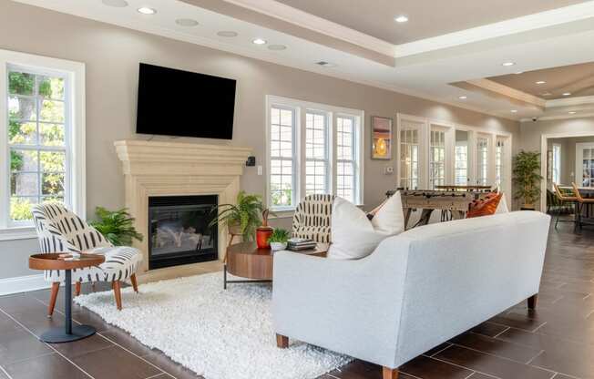 a living room with a fireplace and a tv above it