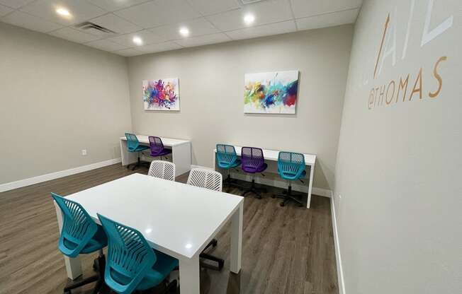 a conference room with a white table and blue chairs