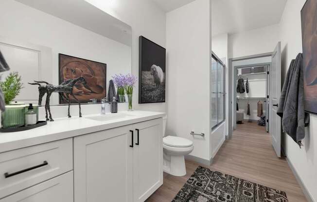 A bathroom with a white toilet and a sink.