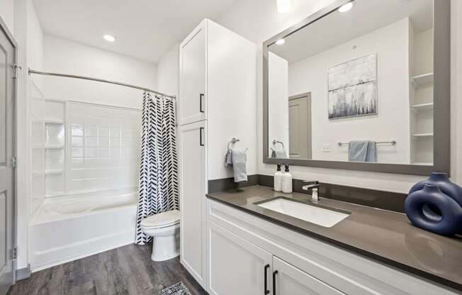 a bathroom with a large mirror and a toilet and a shower at The Quarry Luxury Apartment Homes, Fort Collins