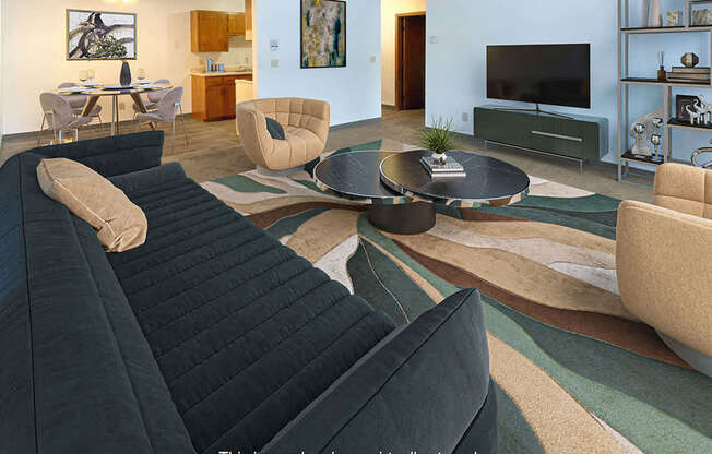 A living room with a black sofa and a coffee table.