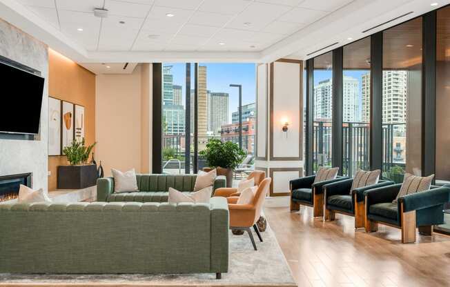 a living room with couches and chairs and a view of the city  at Cassidy on Canal, Chicago, Illinois