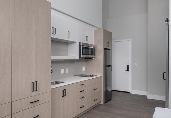 a kitchen with a stove top oven next to a refrigerator