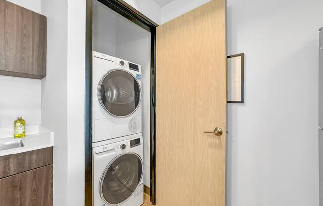 a small laundry room with a washer and dryer in a door