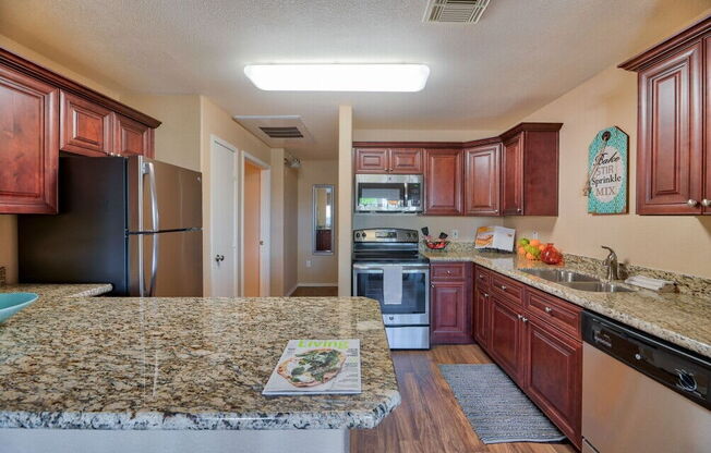 a kitchen with a granite counter top at Villas on Bell, Phoenix, AZ