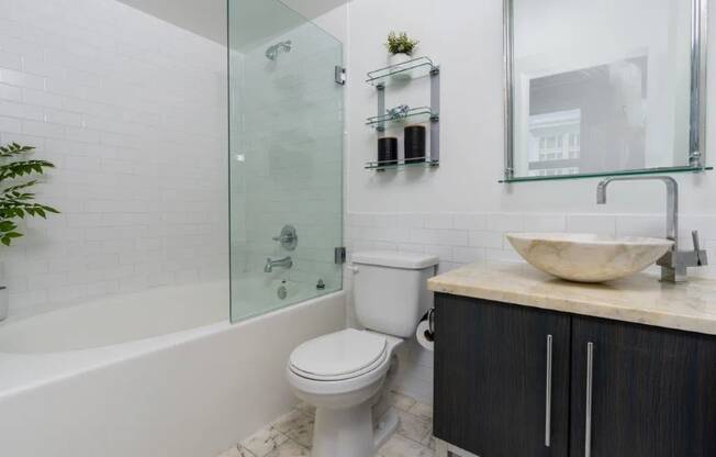 a bathroom with a toilet and a shower and a sink