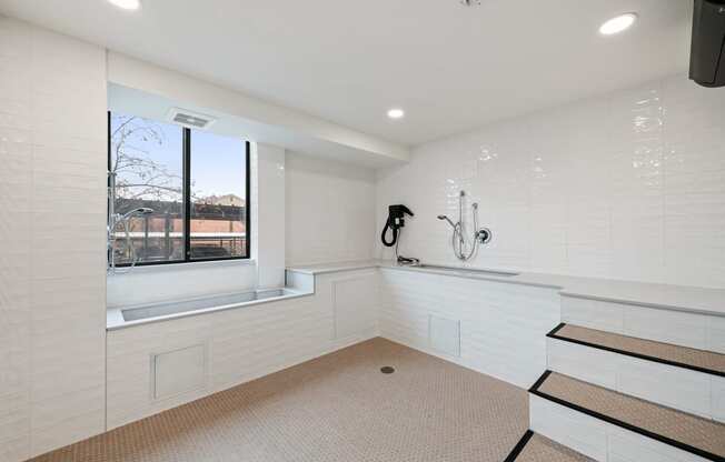 a large white bathroom with a large window