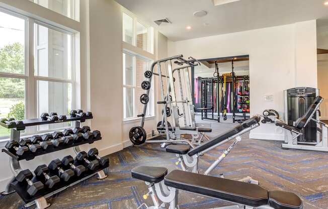 Fitness center with free weights and strength training at Berkshire Ballantyne apartments